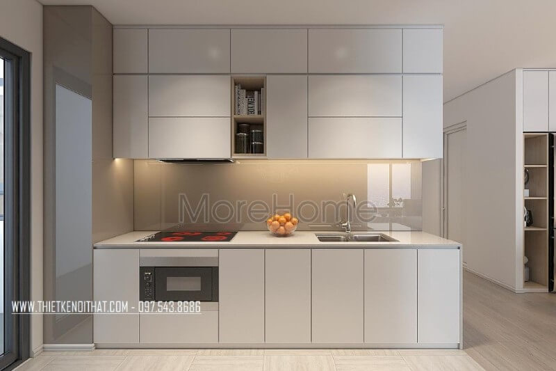 Mẫu tủ bếp kiểu dáng chữ i gỗ acrylic màu trắng kết hợp phân chia các ngăn tủ một cách hợp lí, tạo cho người nội trợ thuận tiện hơn trong quá trình mang lại những bữa cơm ngon miệng cho những người thân yêu của mình Tủ bếp chung cư